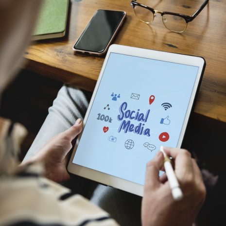 Woman drawing social media icons on a screen